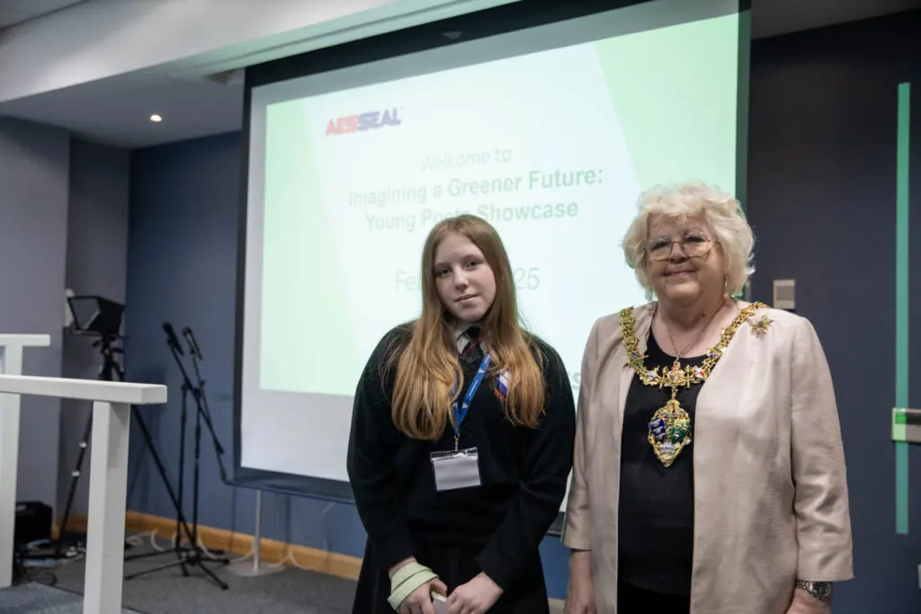 Isabelle (left) being presented with a £100 book token by then Mayor of Rotherham Cllr Sheila Cowen (right)